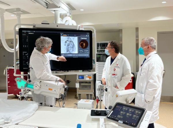 Viewing a test image, from left: William Prabhu, associate medical director of interventional cardiology; Giora Weisz; Howard Tarkin, cardiologist.