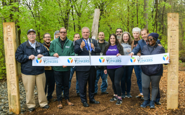 Mayor Mike Spano, surrounded by city officials and well-wishers, gets ready to cut the ribbon opening Henning Park. Photo by Maurice Mercado, City of Yonkers.