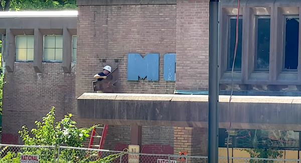 Taking down Y sign at former YMCA in Poughkeepsie.