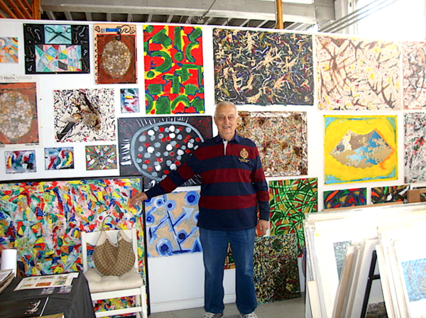 Gino Civale with some of his paintings.