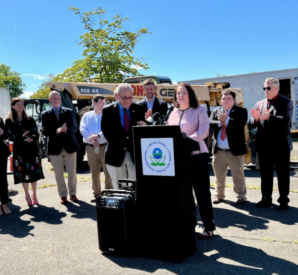 Sen. Schumer to left of the podium as the EPA's Garcia speaks at iPark 87.