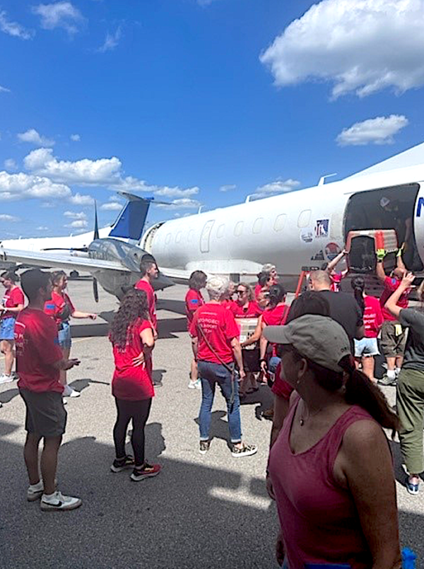 Volunteers unload animals from cargo plane that arrived at Westchester County Airport.