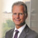 BANK EXEC TAKES ON EXPANDED ROLE